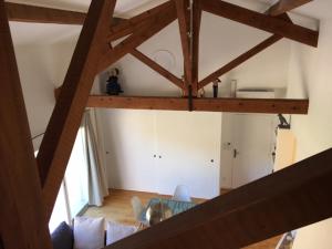 a living room with a glass table and wooden beams at Appartements Les Pesquiers 2 Hyères Plage in Hyères +15 photos