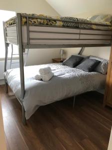 a bedroom with a bunk bed with two towels on it at Skellig View House in Waterville