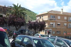 a parking lot with cars parked in front of a building at Caçula, Alojamento Local in Torre de Moncorvo