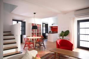 a living room with a table and red chairs at RONDAPLACE APTO in Ronda