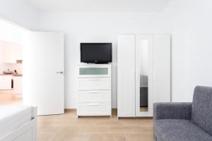 a living room with a tv and a couch at The wave house El Médano in El Médano