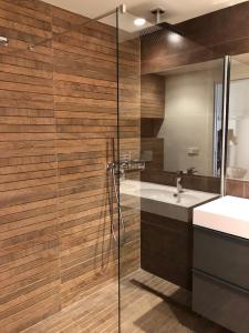 a bathroom with a glass shower and a sink at Cabopino in Marbella