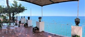 a balcony with a table and chairs and the ocean at Hotel Marincanto in Positano