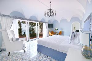 a bedroom with a bed and a table and chairs at Hotel Marincanto in Positano