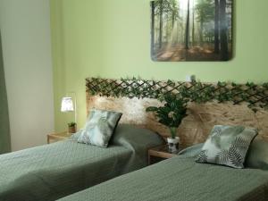 a bedroom with two beds and a picture on the wall at Nature Guesthouse in Lagos