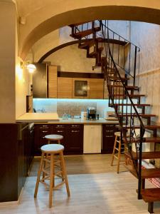 a kitchen with a spiral staircase in a kitchen at Eroilor Apartment in Cluj-Napoca