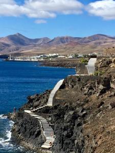 a group of stairs on a rocky shore next to the water at Velero MissTick,Gibsea 47'2 in Puerto Calero