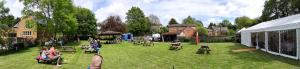 a group of people sitting on chairs in a yard at The Pear Tree in Hook Norton