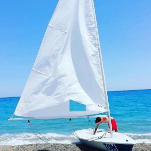 a man on a sail boat on the beach at Luna Apartments in Badolato