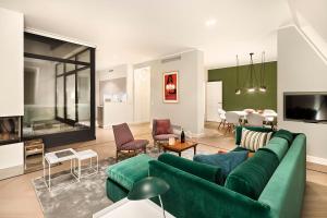 a living room with a green couch and a dining room at Lux 11 Berlin-Mitte in Berlin