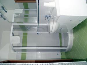 a bathroom with a mirror and a sink at Rifugio Fedaia in Malga Ciapela