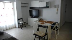 a small kitchen with a small table and chairs at Apartamento Portalet 7 in Benaguacil