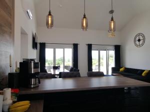 a kitchen and living room with a large wooden table at Villa Orao in Kastel Novi