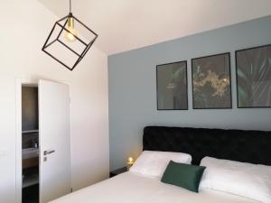 a bedroom with a white bed and a black headboard at Villa Orao in Kastel Novi +50 photos