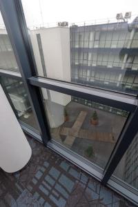 a view from a window of a courtyard with a potted plant at AMI Penthouse in Palanga