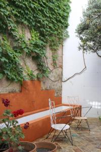 dos sillas y una mesa frente a una pared en RONDAPLACE, en Ronda