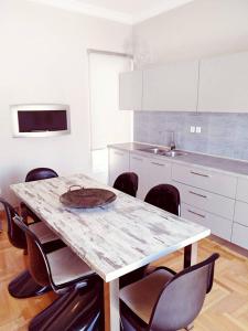 a kitchen with a table and chairs with a plate on it at The Athens Museum Penthouse 120sqm Lycabettus View in Athens