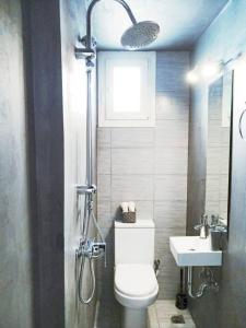 a bathroom with a toilet and a sink at The Athens Museum Penthouse 120sqm Lycabettus View in Athens