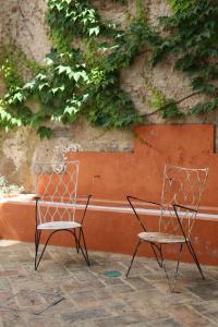 dos sillas sentadas frente a una pared en RONDAPLACE, en Ronda
