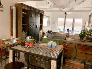 a kitchen with an island with apples on it at Jacob's View in Falmouth