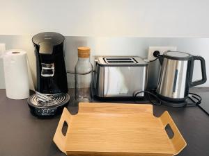 a kitchen counter with a cutting board and a coffee maker at ALPS COCOON in Annecy