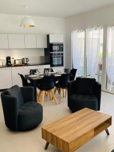 a kitchen and living room with a table and chairs at ALPS COCOON in Annecy