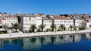 a view of a city with a river and buildings at Apartments and Rooms Jospino in Mali Lošinj