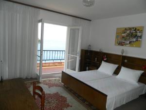 a bedroom with a bed with a view of the ocean at Apartments Mercep in Dubrovnik