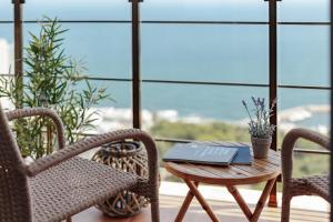 a table and chairs with a laptop on it on a balcony at Sea & Sky apartments in Odesa