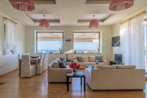 a living room with two couches and a table at Eco Villa Makri in Makri
