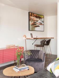 a living room with a chair and a table at RSVP Hotel in Bozeman
