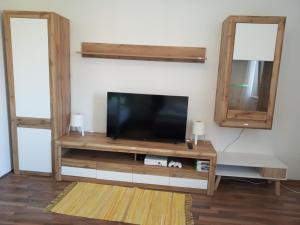 a living room with a tv and a mirror at Apartment Beli Kriz in Piran +17 photos