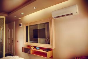 a room with a window and a tv on the wall at Upper House in Kaş