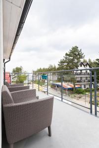 a balcony with chairs and a view of a playground at Rafa przy Plaży in Sztutowo