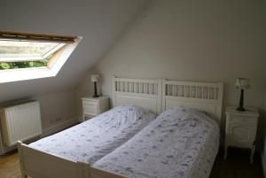 Tempat tidur dalam kamar di Au Coeur de la Famille
