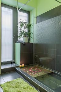 a bathroom with a shower with pink flowers on the floor at Eco Villa Makri in Makri