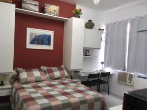 1 dormitorio con cama y escritorio en Cosy studio in Copacabana, en Río de Janeiro