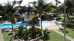 an aerial view of a resort with a pool and palm trees at Apart Condomínio Jubiabá in Ilhéus +34 photos
