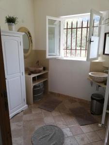 a bathroom with two sinks and a window at Mas Saint Louis in Saignon +66 photos