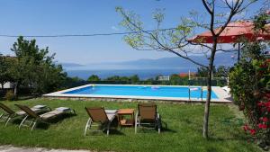 a yard with chairs and a swimming pool at Casa Bellavista in Rijeka