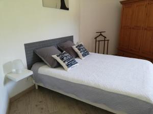 a bedroom with a bed with two pillows on it at Mas Saint Louis in Saignon