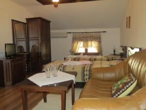 a living room with two beds and a couch at Oazis Guesthouse in Lovech
