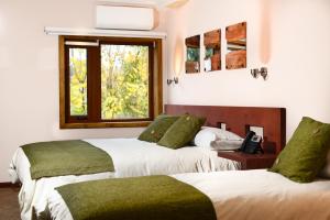 Ein Bett oder Betten in einem Zimmer der Unterkunft Hotel Pucón Indómito