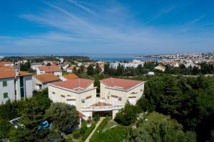 an aerial view of a large house in a city at Apartments Dvori Novalja in Novalja