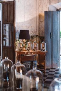 a table with a lamp on it in a room at Coqui Coqui Casa de los Santos Izamal - THE ONLY ONE SUITE COLLECTION in Izamal