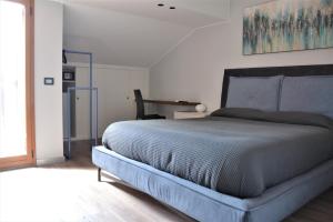a bedroom with a large bed and a window at Etna Sunrise b&b in Zafferana Etnea