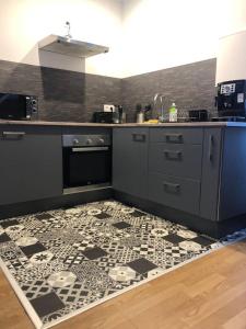 a kitchen with a black and white tile floor at Le Duplex in Cherbourg en Cotentin +9 photos