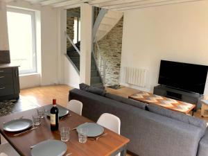 a living room with a couch and a table at Le Duplex in Cherbourg en Cotentin