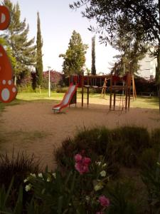 a playground with a slide in a park at Appartement meublé sécurisé in Agadir