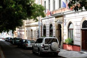 a car parked on a street in front of a building at Hotel Petr in Prague